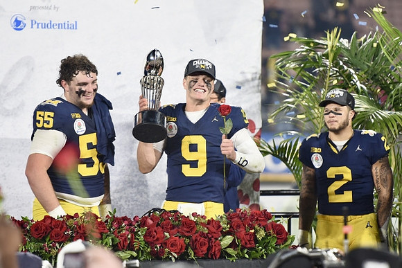 Mason Graham (55), J.J. McCarthy (9), Blake Corum (2), and Rose Bowl Trophy
