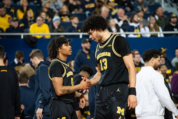 Dug McDaniel (0) and Olivier Nkamhoua (13)
