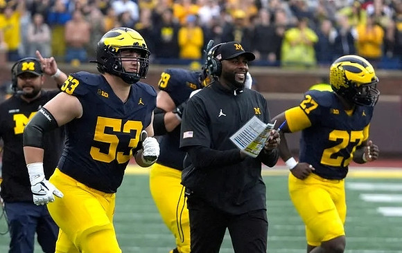 Liam Groulx (53), Sherrone Moore, and Tyler McLaurin (27)