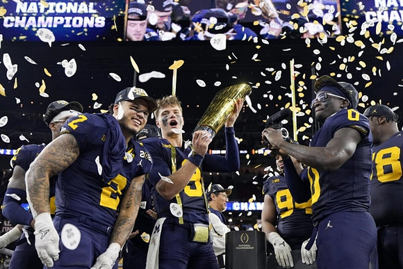 Will Johnson (2), Blake Corum (2), J.J. McCarthy (9), Kris Jenkins (94), Mike Sainristil (0), Kenneth Grant (78), and National Championship Trophy