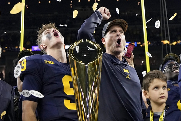 J.J. McCarthy (9), Jim Harbaugh, and National Championship Trophy