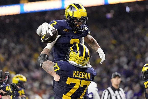 Blake Corum (2) and Trevor Keegan (77)