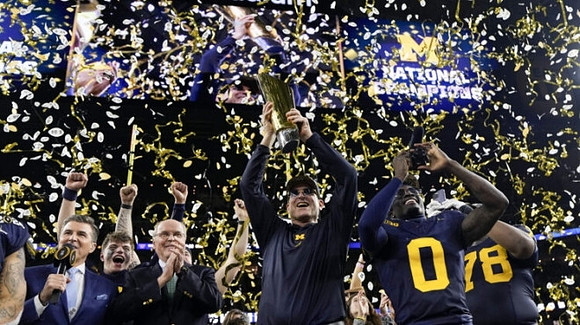 J.J. McCarthy (9), Jim Harbaugh, Mike Sainristil (0), Kenneth Grant (78), and National Championship Trophy