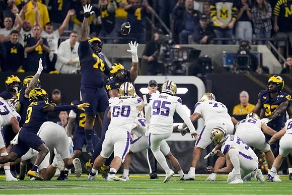 Mike Sainristil (0), Kenneth Grant (78), and Jaylen Harrell (32)