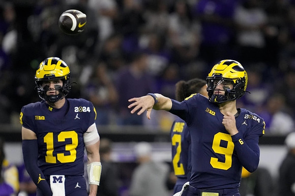 Jack Tuttle (13) and J.J. McCarthy (9)