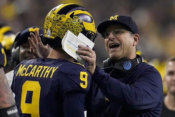 J.J. McCarthy (9) and Jim Harbaugh