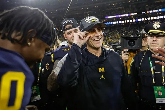 Trevor Keegan (77) and Jim Harbaugh