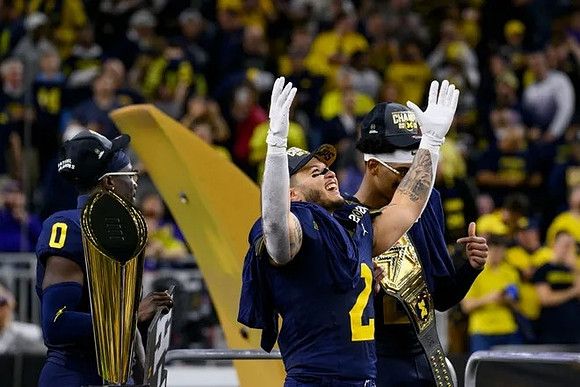 Mike Sainristil (0), Blake Corum (2), Will Johnson (2), and National Championship Trophy