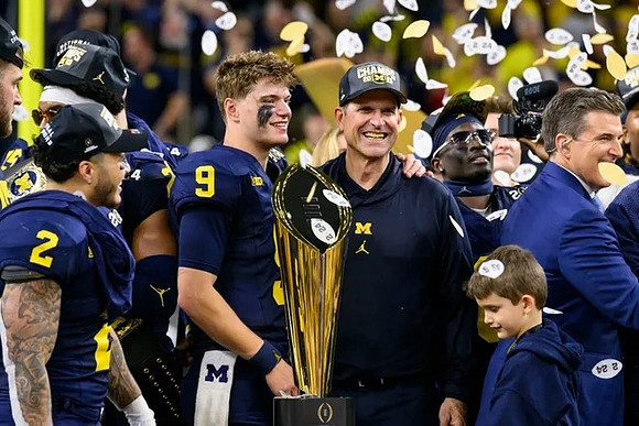 Blake Corum (2), J.J. McCarthy (9), Jim Harbaugh, Mike Sainristil (0), and National Championship Trophy