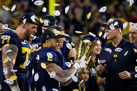 Trevor Keegan (77), Blake Corum (2), Jim Harbaugh, and National Championship Trophy