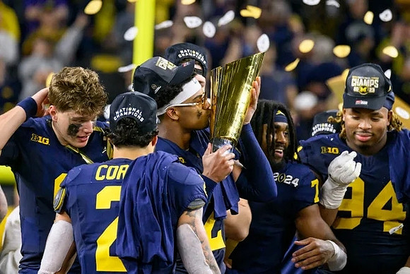 J.J. McCarthy (9), Blake Corum (2), Will Johnson (2), Donovan Edwards (7), Kris Jenkins (94), and National Championship Trophy