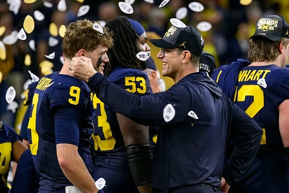 J.J. McCarthy (9), Trente Jones (53), Jim Harbaugh, and Karsen Barnhart (52)