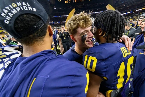 J.J. McCarthy (9) and Alex Orji (10)
