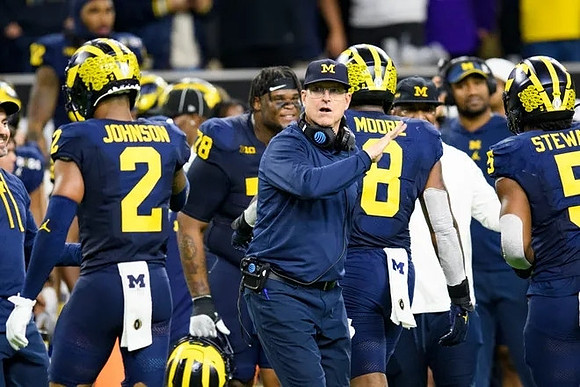 Will Johnson (2), Kenneth Grant (78), Jim Harbaugh, Derrick Moore (8), and Josaiah Stewart (5)