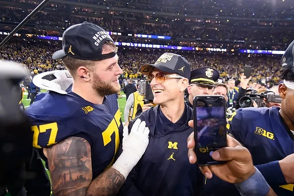 Trevor Keegan (77) and Jim Harbaugh