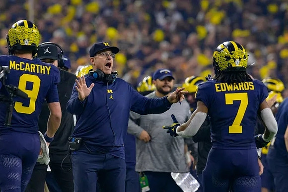 J.J. McCarthy (9), Jim Harbaugh, and Donovan Edwards (7)