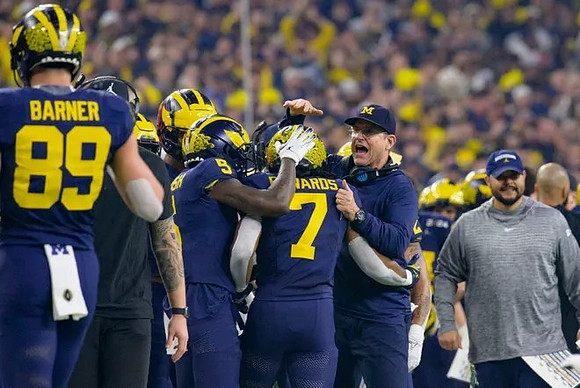 AJ Barner (89), Rod Moore (9), Donovan Edwards (7), and Jim Harbaugh