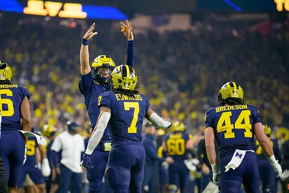 Cornelius Johnson (6), J.J. McCarthy (9), Donovan Edwards (7), and Max Bredeson (44)