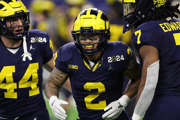 Max Bredeson (44), Blake Corum (2), and Donovan Edwards (7)