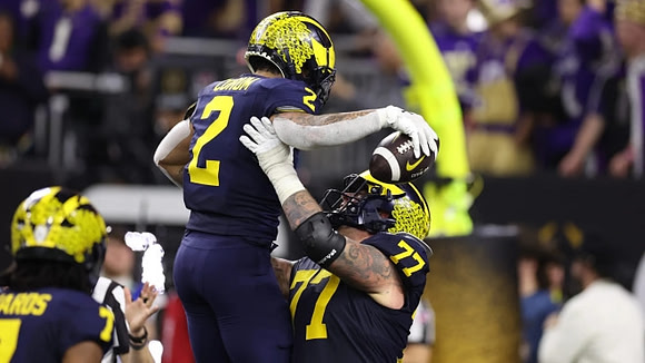 Donovan Edwards (7), Blake Corum (2), and Trevor Keegan (77)
