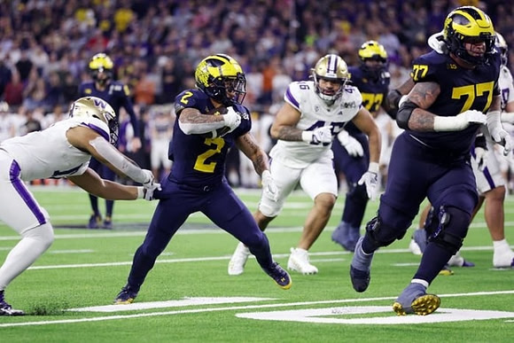 Blake Corum (2), Donovan Edwards (7), and Trevor Keegan (77)