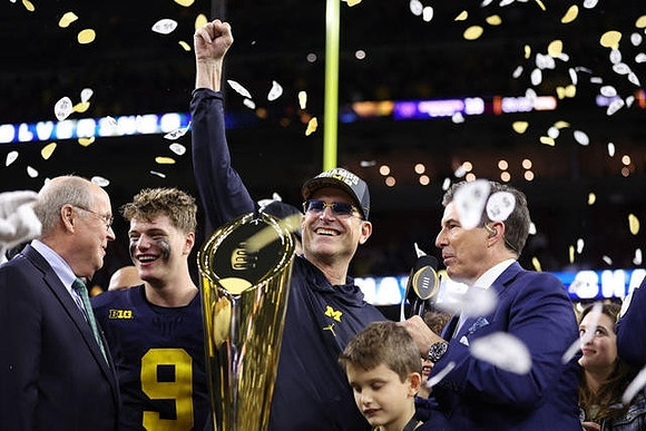 J.J. McCarthy (9), Jim Harbaugh, and National Championship Trophy