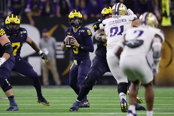Drake Nugent (60), Donovan Edwards (7), J.J. McCarthy (9), and Trevor Keegan (77)
