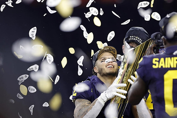 Blake Corum (2), Mike Sainristil (0), and National Championship Trophy