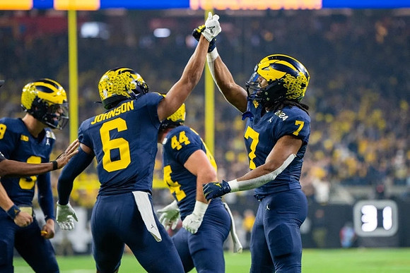 J.J. McCarthy (9), Cornelius Johnson (6), Max Bredeson (44), and Donovan Edwards (7)