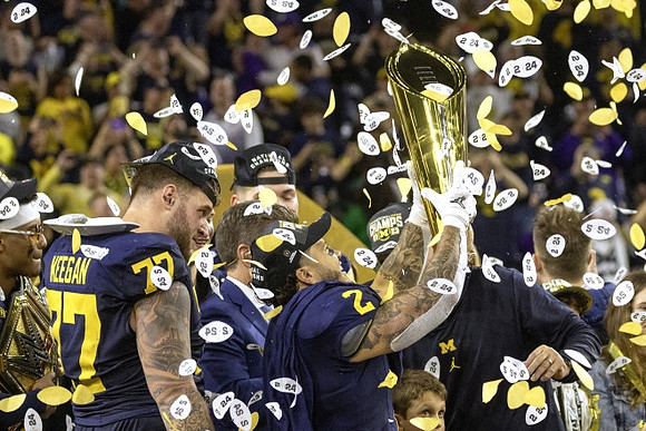 Blake Corum (2), Michigan Team, and National Championship Trophy