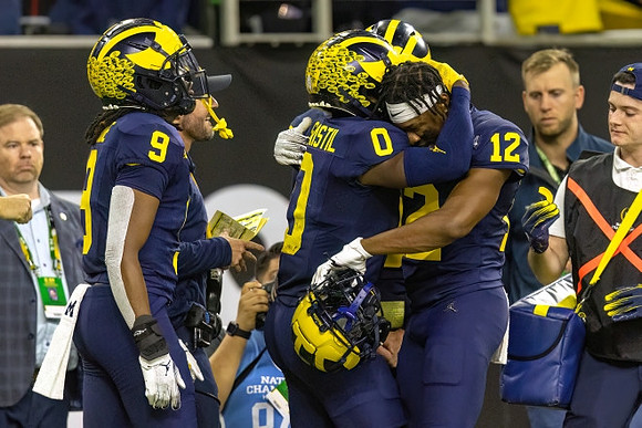 Rod Moore (9), Mike Sainristil (0), and Josh Wallace (12)