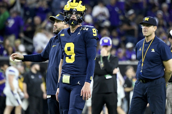 J.J. McCarthy (9) and Jim Harbaugh