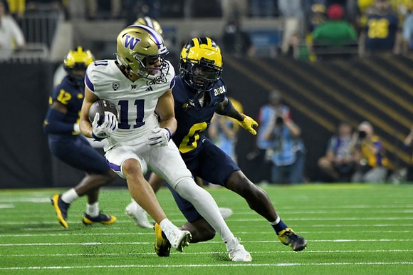 Josh Wallace (12) and Mike Sainristil (0)