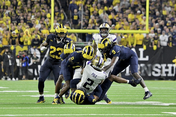Michael Barrett (23), Keon Sabb (3), Mike Sainristil (0), and Rod Moore (9)