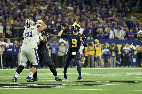 Trevor Keegan (77) and J.J. McCarthy (9)
