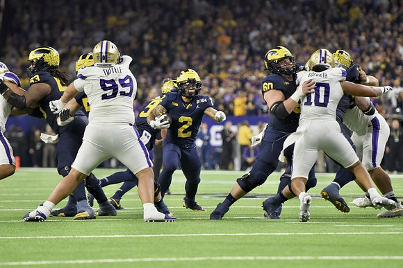 Trente Jones (53), Blake Corum (2), and Drake Nugent (60)