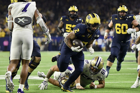 Trente Jones (53), Blake Corum (2), and Drake Nugent (60)