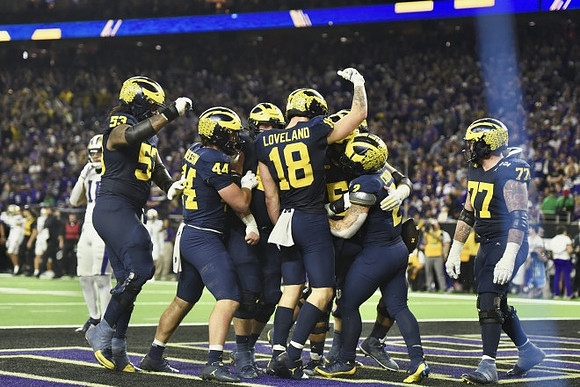 Trente Jones (53), Max Bredeson (44), Colston Loveland (18), Blake Corum (2), and Trevor Keegan (77)