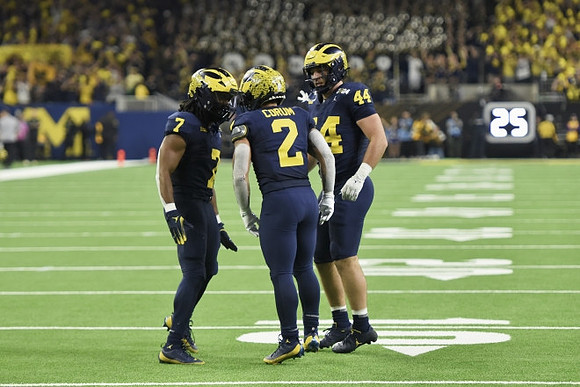 Donovan Edwards (7), Blake Corum (2), and Max Bredeson (44)