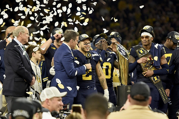 Blake Corum (2), Mike Sainristil (0), Will Johnson (2), Kenneth Grant (78), and National Championship Trophy