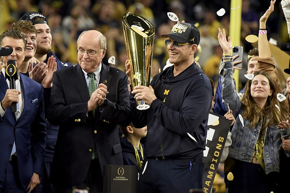 J.J. McCarthy (9), Jim Harbaugh, and National Championship Trophy
