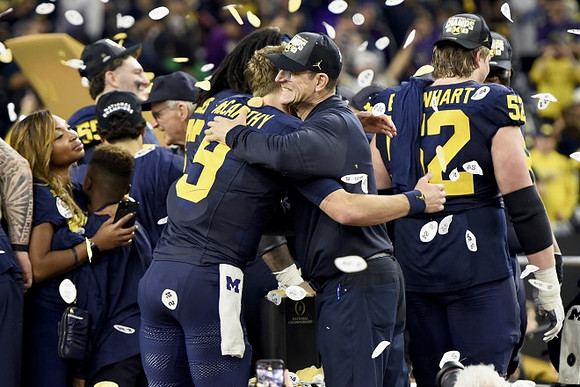 J.J. McCarthy (9), Jim Harbaugh, and Karsen Barnhart (52)