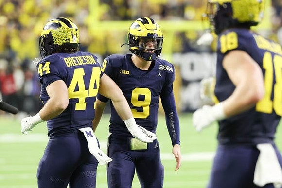 Max Bredeson (44), J.J. McCarthy (9), and Colston Loveland (18)