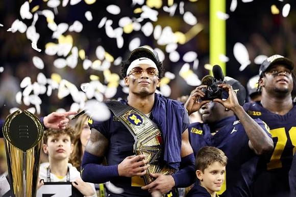 Will Johnson (2), Mike Sainristil (0), Kenneth Grant (78), and National Championship Trophy