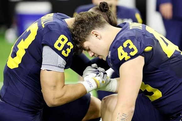 Zack Marshall (83) and J.J. McCarthy (9)
