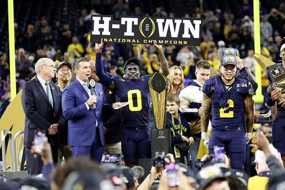 UofM President Santa Ono, Mike Sainristil (0), Blake Corum (2), and National Championship Trophy