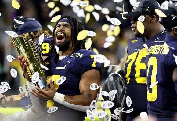 Donovan Edwards (7), Kenneth Grant (78), Mike Sainristil (0), and National Championship Trophy