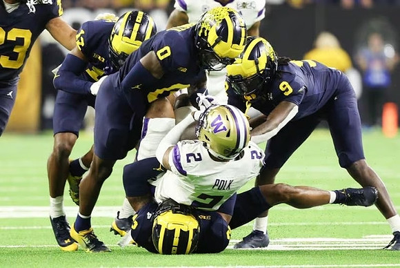 Michael Barrett (23), Josh Wallace (12), Mike Sainristil (0), Rod Moore (9), and Will Johnson (2)