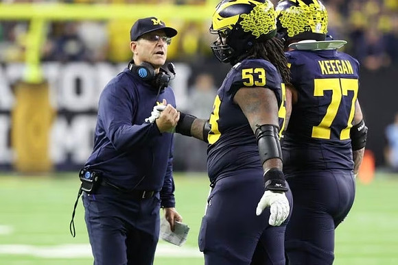 Jim Harbaugh, Trente Jones (53), and Trevor Keegan (77)