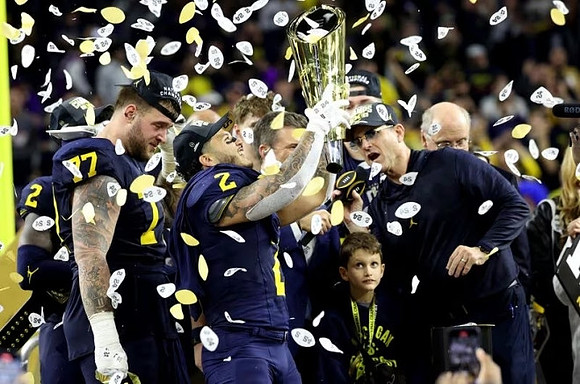 Will Johnson (2), Trevor Keegan (77), Blake Corum (2), Jim Harbaugh, and National Championship Trophy